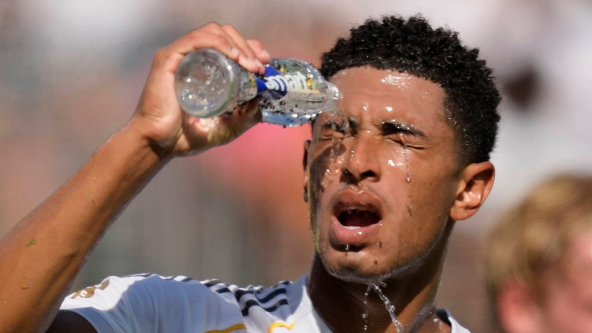 Hard to endure: Real star Jude Bellingham refreshes himself with a little water.