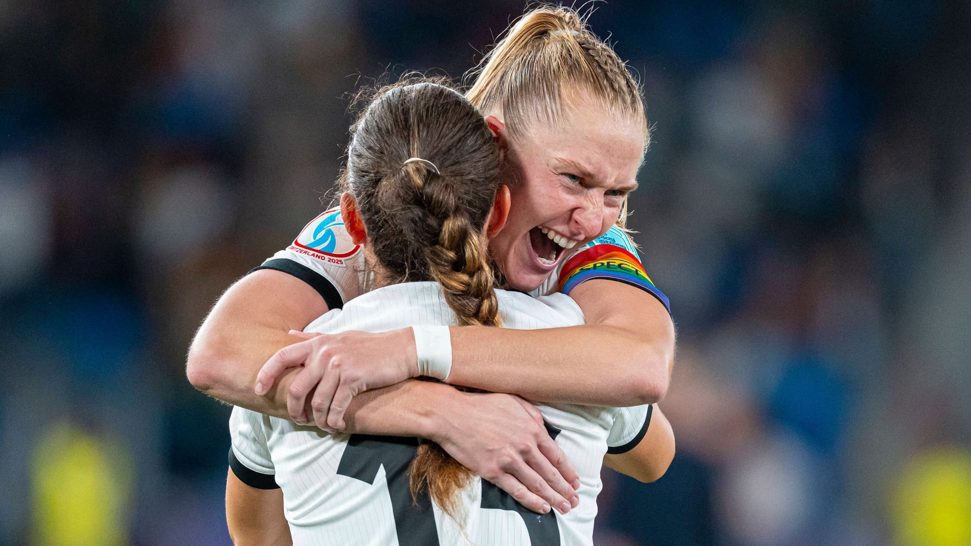 Overjoyed: Janina Minge hugs teammate Sara Däbritz after the game.