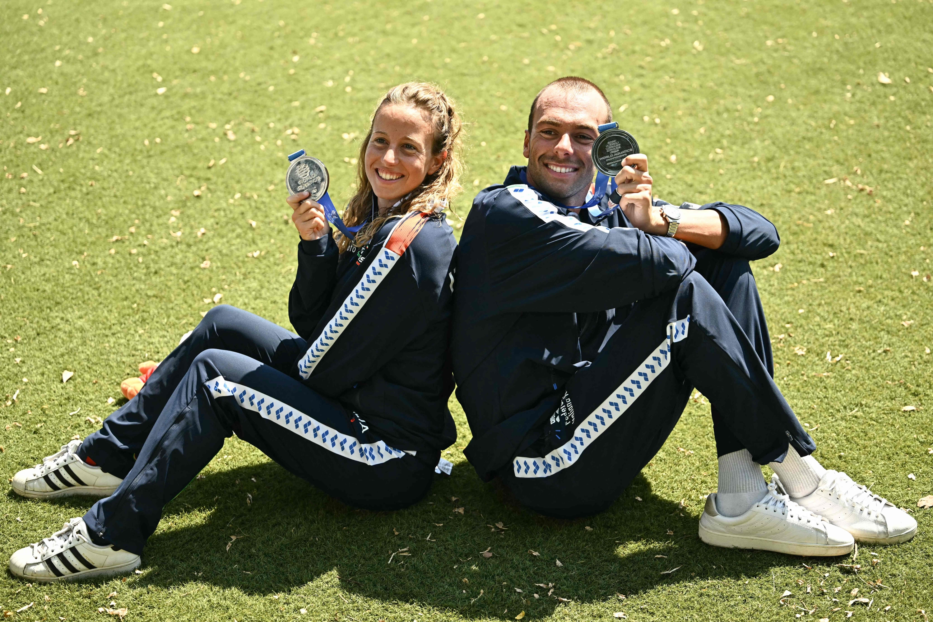 Second-Placed Italy's Swimmer Gregorio Paltrinieri (R) in the Men's 5km Open Water Swimming Event, and Second-PlamoD Italy's Swimmer Geneva Taddeucci in The Women's 5km Open Water Swimming Event Celebrate With Their Silver Medals Following Their Races During the 2025 World Aquatics Championships at Sentosa Island in Singapore on July 18, 2025. (Photo by Manan Vatsyayana / Afp)