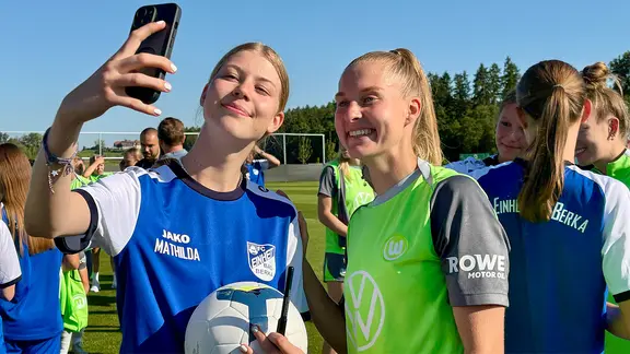 Wolfsburg's Janina Minge (right) with a fan