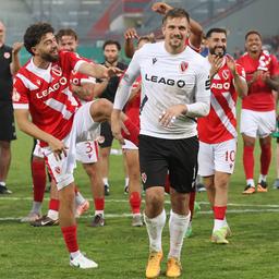Goalkeeper Alexander Sebald is celebrated by his Cottbus teammates after the first round victory against Hannover 96 in the trophy