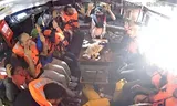 The Madleen crew holds its hands in the air after the Israeli army entertained the ship on Monday. Photo Freedom Flotilla Coalition 