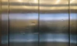 Damaged lift doors in the Detroit complex of Vesteda on the Veemkade in Amsterdam.