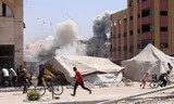 Palestinians seek coverage after an Israeli attack on a building in Jabalia in the north of the Gaza Strip. Photo Bashar Taleb/AFP 