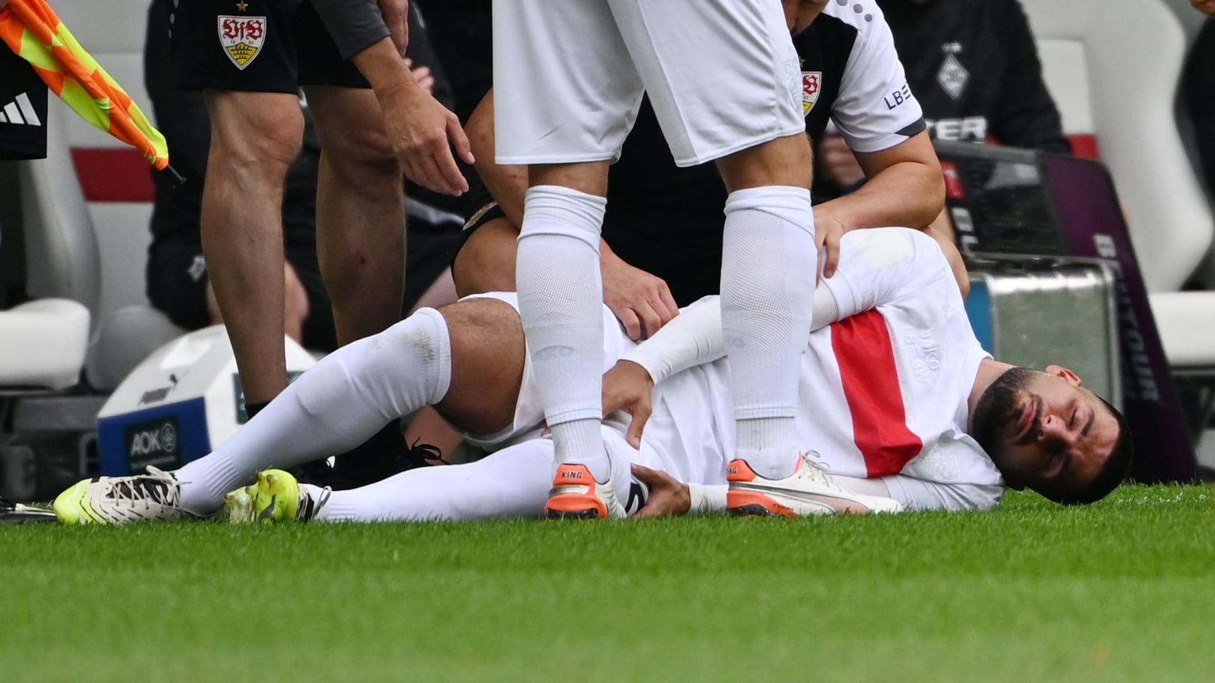 On the ground: Stuttgart attacker Deniz Undav is treated in the game against Gladbach.