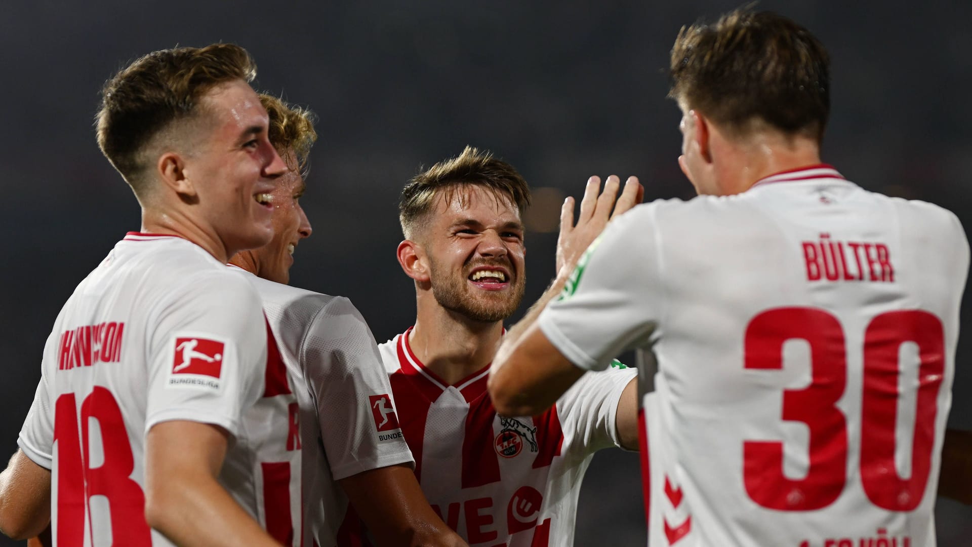 RheinEnergieStadion: Isak Johannesson, Jan Thielmann and Marius Bülter (from left to right) celebrate after the victory against Freiburg.