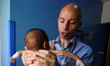 The Palestinian doctor Ahmed Basal is investigating a child in the Al-Rantisi hospital in Gaza City on August 7.