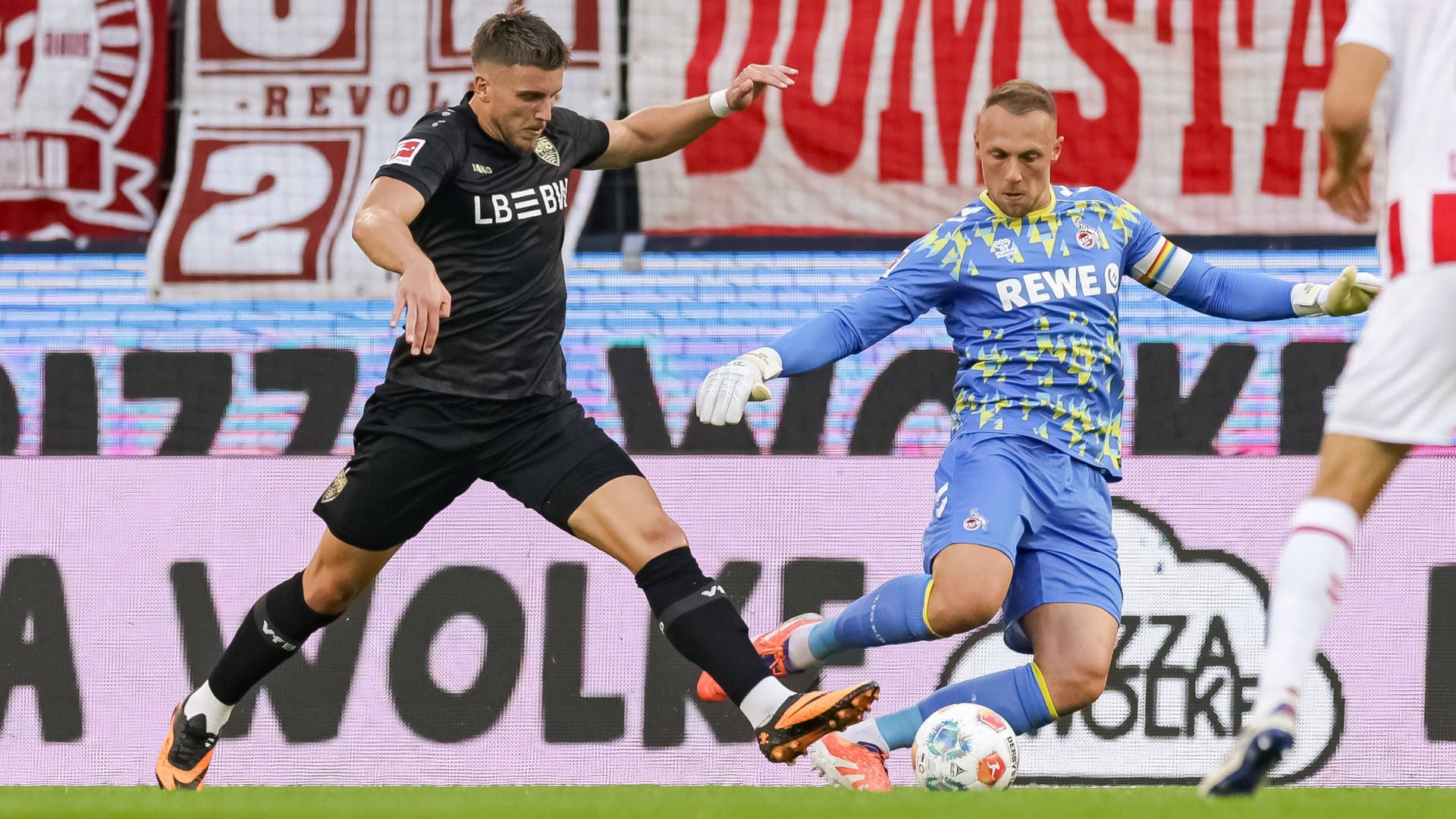 The controversial scene: Stuttgart's Demirović (left) comes down in a duel with Cologne goalkeeper Schwäbe.