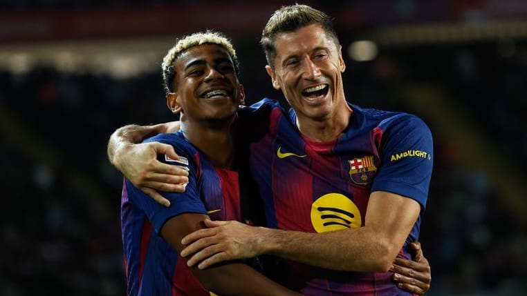 In a playful mood: Barcelonas Lamine Yamal (left) and Robert Lewandowski celebrate against Real Sociedad.