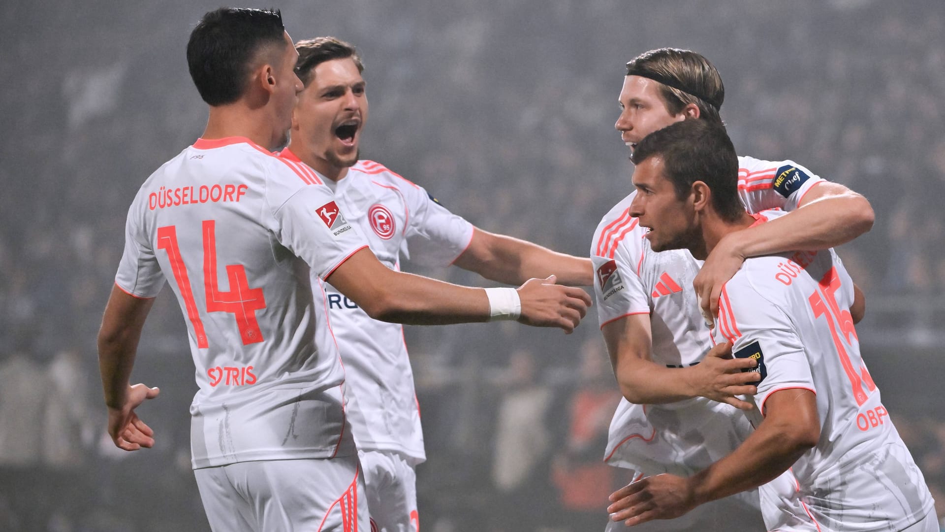 The winning goal: Düsseldorf's Tim Oberdorf (right) is celebrated by his teammates.