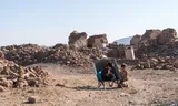 Children play with the wheelbarrows that residents used to look for victims of the heavy earthquakes in the Afghan province of Herat in the ruins of their destroyed houses. 