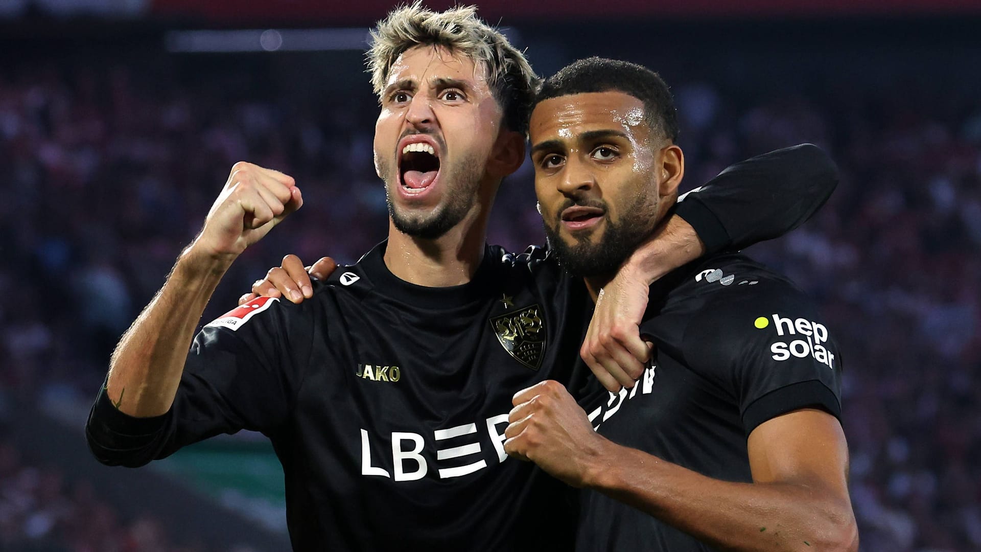 Game shot: Stuttgart's Karazor (left) and scorer Vagnoman cheer.