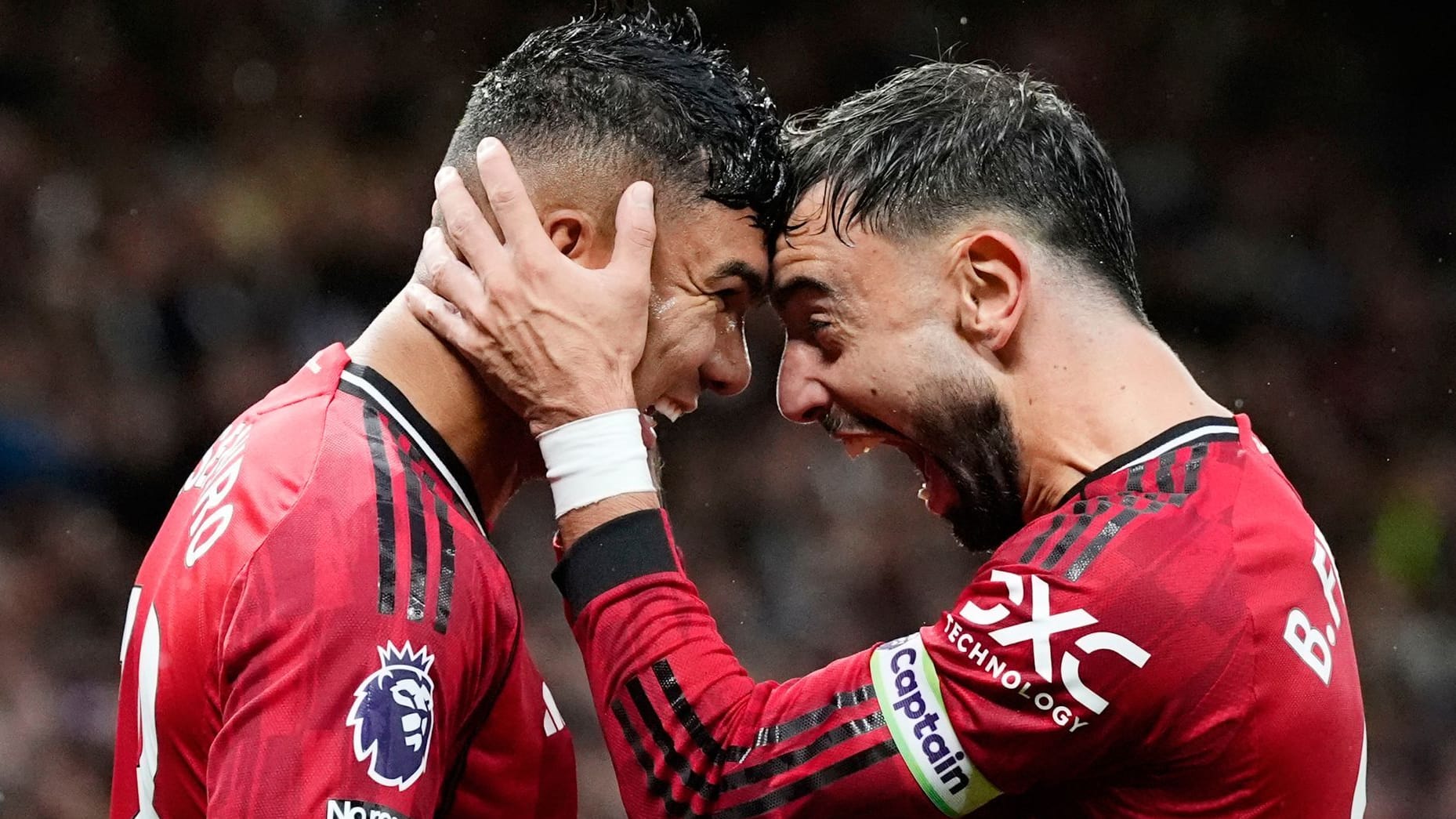 In a party mood: Casemiro (left) is raised by Bruno Fernandes for his goal against Chelsea.