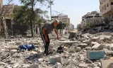 A resident of Gaza City among the rubble of a residential area after an Israeli attack on Saturday. Photo Ebrahim Hajjaj / Reuters