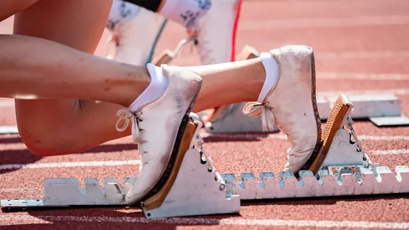 A starting block for runners on a tartan track.