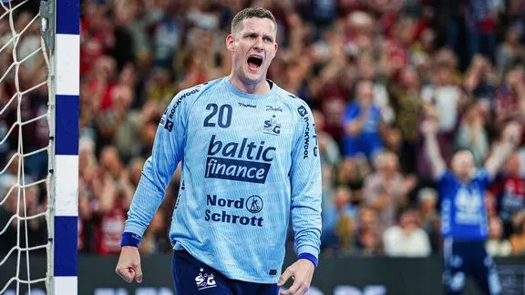 Flensburg's Kevin Möller cheers after a parade