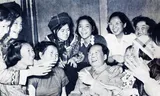 Mao Zedong, then leader of the Communist Party of China, with a group of women in 1957.