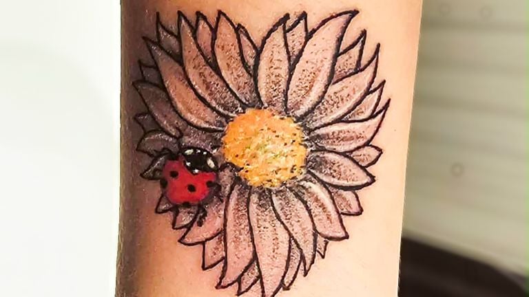 Lin's daisy ladybug tattoo (private photo).