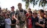 A masked fighter from the Ezzedine al-Qassam Brigades, the armed branch of Hamas, stands guard in Deir el-Balah.