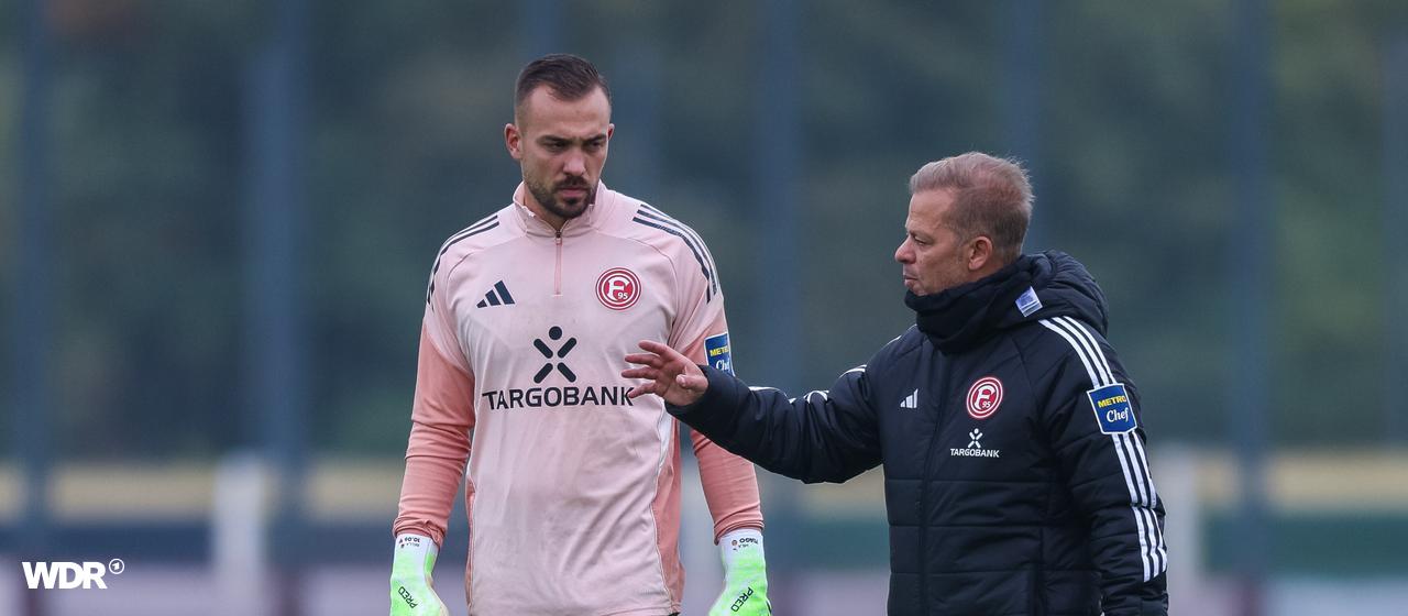 Düsseldorf's coach Markus beginning in conversation with goalkeeper Florian Kastenemeier