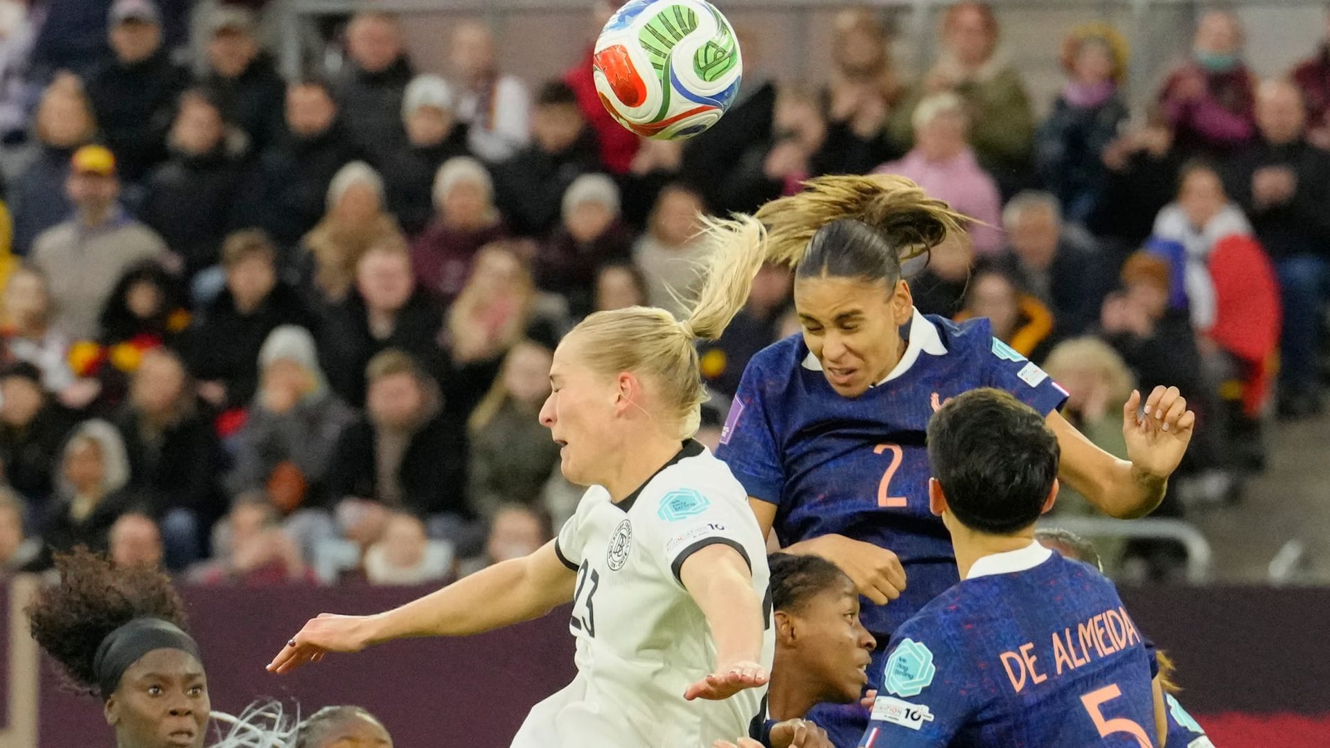Contested: Germany's Camilla Küver and France's Maëlle Lakrar in the header duel.