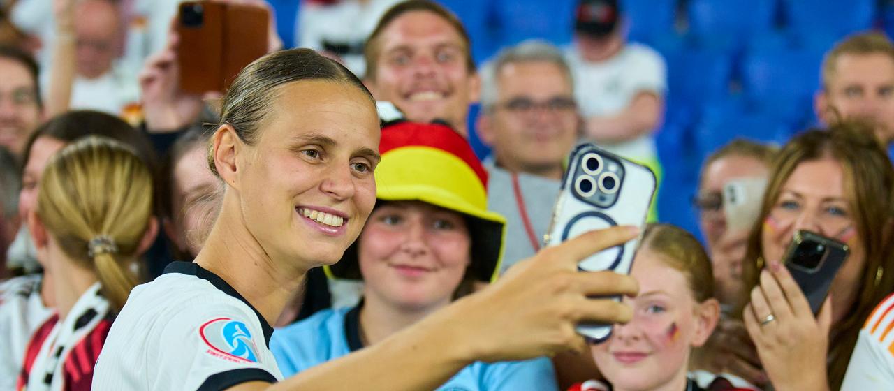 Klara Bühl takes a photo with German fans at the European Championships in the summer
