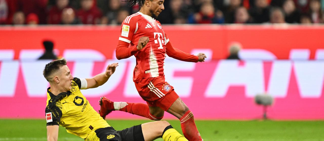 Nico Schlotterbeck tackles Bayern's Michael Olise
