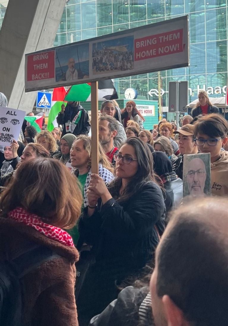 Selin during a protest at The Hague station Thursday, with a photo of her father (photo: Free Palestine Boz).