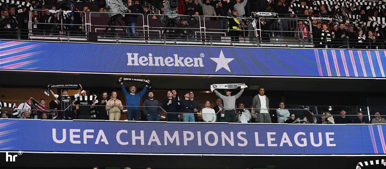 Eintracht fans hold up their scarves during the Champions League game against Liverpool.