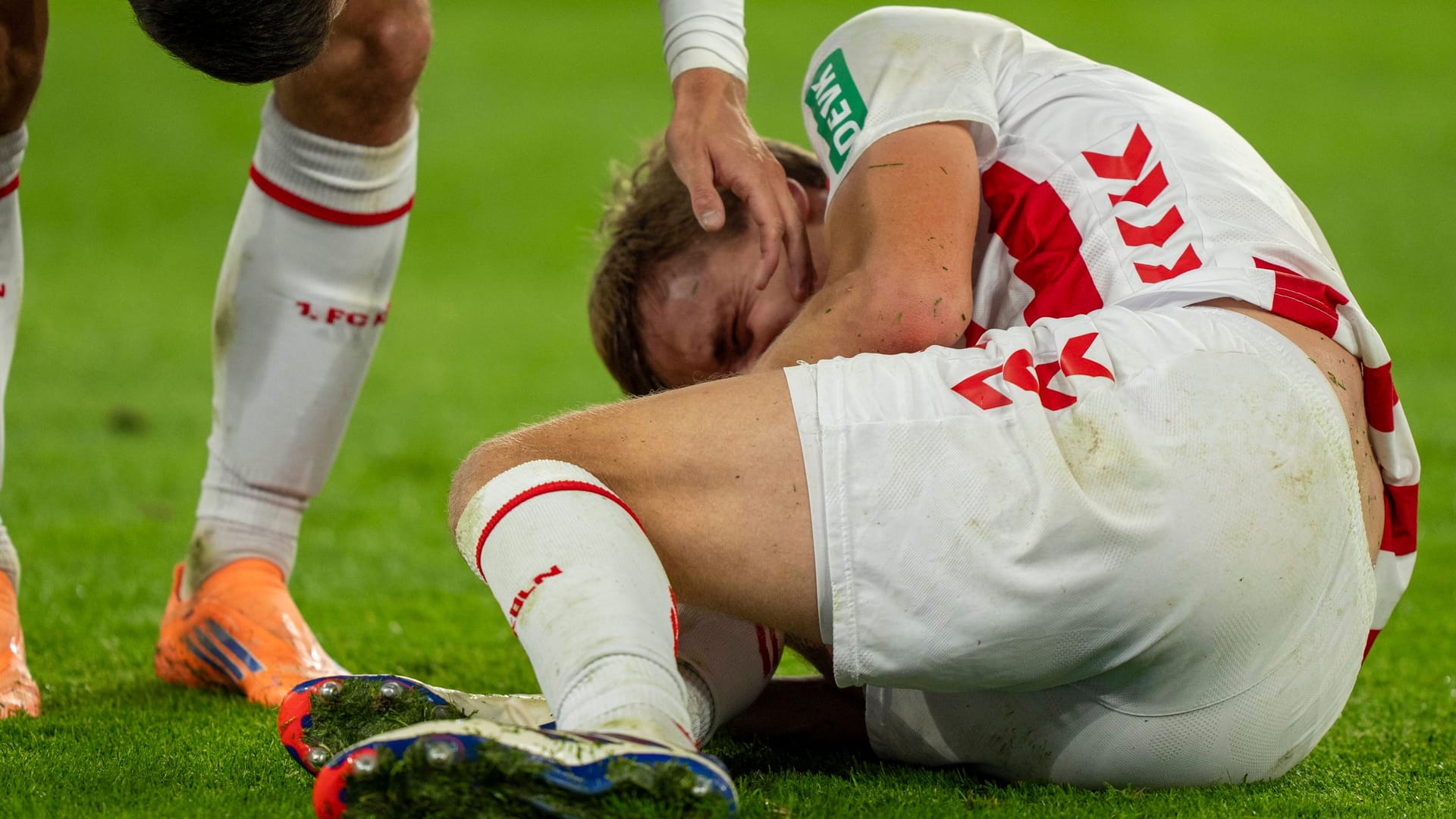 Scary moments: Cologne's Timo Hübers on the ground.