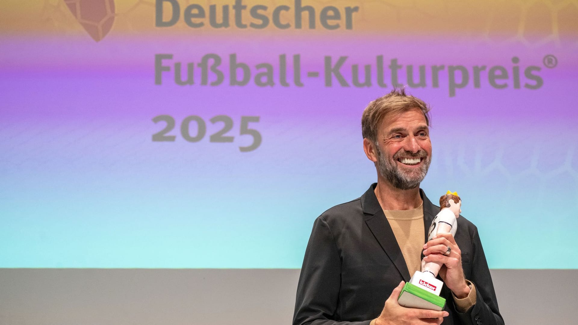 Jürgen Klopp, former soccer player and coach as well as Global Head of Soccer at Red Bull, holds his award in his hand at the German Soccer Culture Award ceremony in Nuremberg.