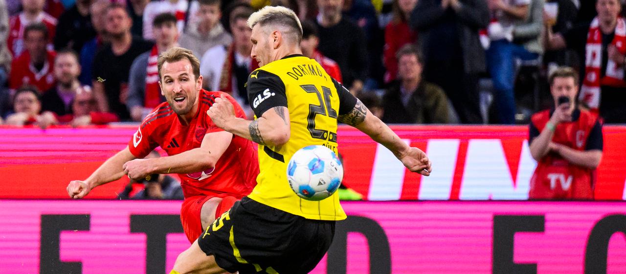 Bayern's Harry Kane (l.) and Dortmund's Nico Schlotterbeck