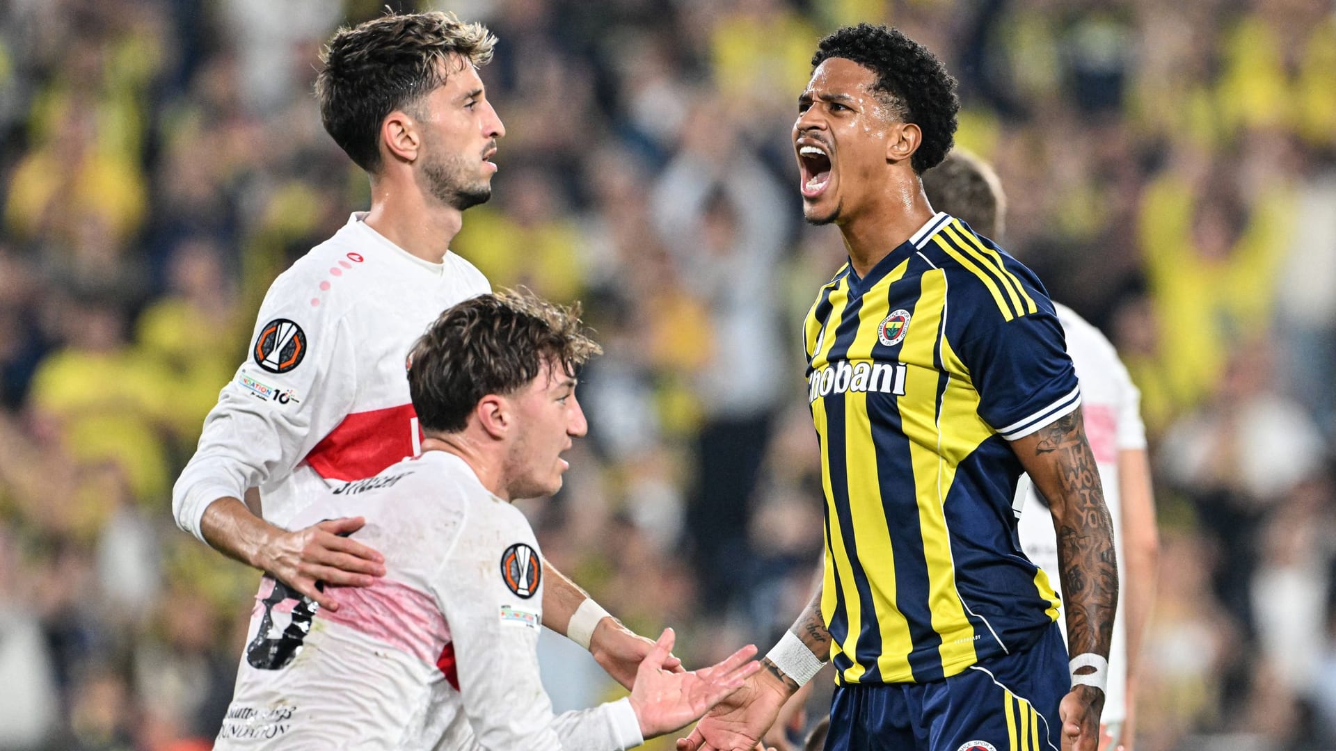 Worlds of emotions: Stuttgart's Karazor and Stiller (left) in front of Fener's Oosterwolde.