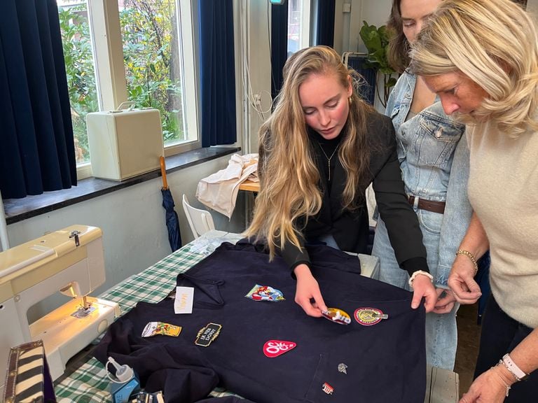 Rowan looks at where the emblems should be placed on her smocks (photo: Megan Hanegraaf). 