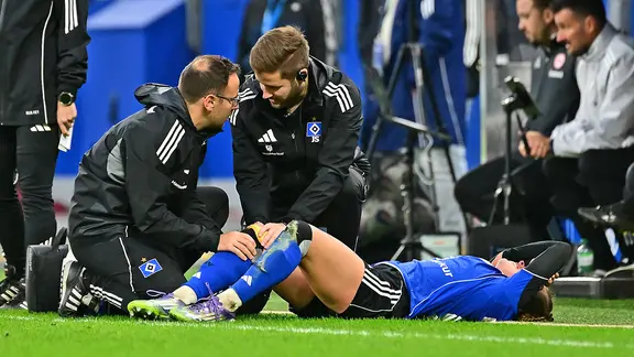 Attacker Viktoria Schwalm from Hamburger SV is injured on the ground 