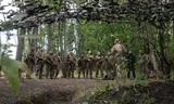 Foreign volunteers of the Khartiia Brigade during training in the forest in the Kharkiv region. 