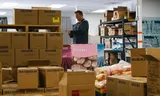 Chad Akers of Hungry Lambs among his supplies of food aid.