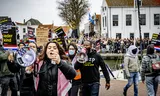 Supporters of the action group Kick Out Zwarte Piet (KOZP) during a demonstration at a Sinterklaas arrival in Middelharnis in 2024.