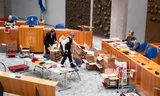 Officials check the official reports of all polling stations in the plenary hall of the House of Representatives. 