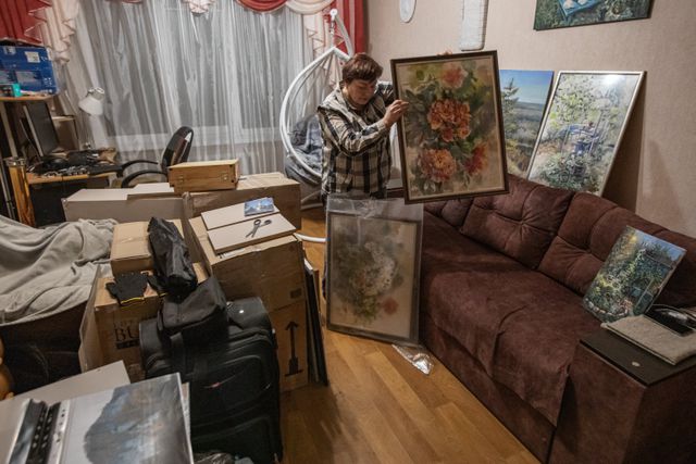 Olena Melnikova packs her paintings before leaving Kramatorsk.