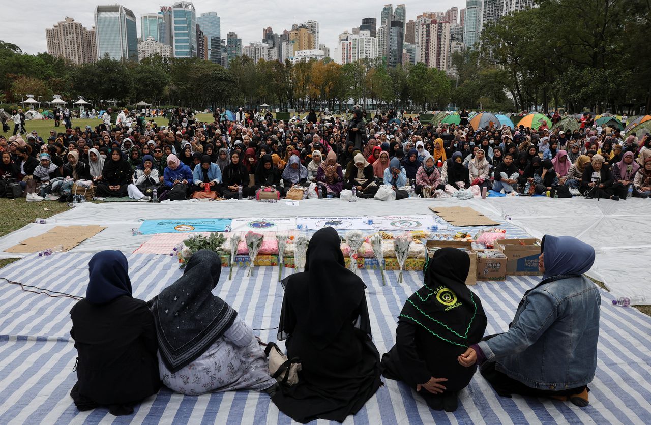 Mourners attend an Islamic prayer meeting organized by Hong Kong's Indonesian community for the victims at Wang Fuk Court on Saturday.