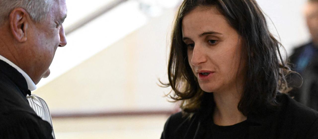 Biathlete Julia Simon speaks with her lawyer Christian Borel