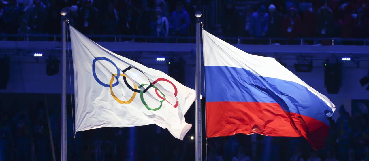Olympic flag next to the Russia flag
