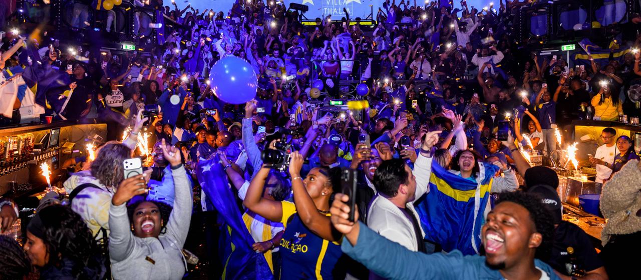 Curacao fans celebrate their first ever World Cup participation in a Rotterdam cafe