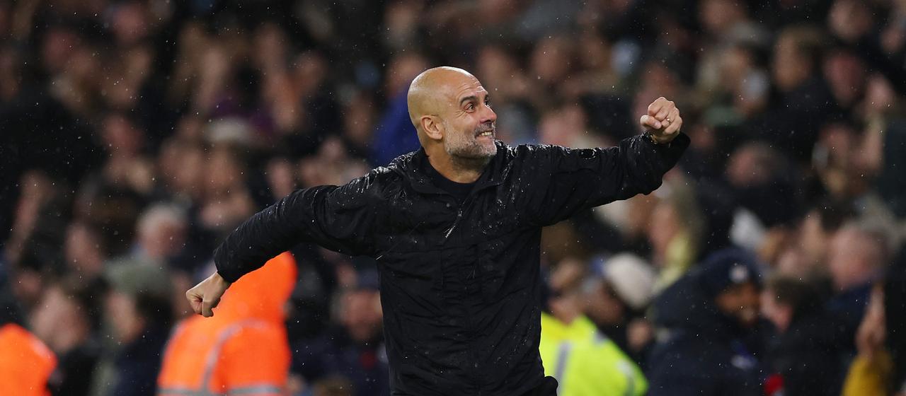 Pep Guardiola celebrates a goal in the game against Liverpool FC