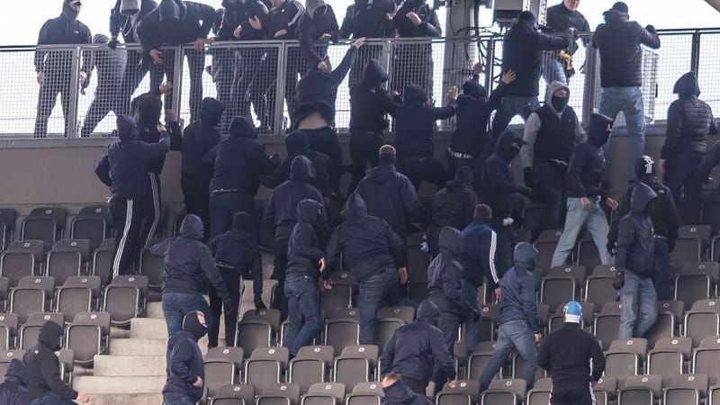 State of emergency before kick-off: Dynamo Dresden football fans (above) engage in a brawl with Hertha BSC fans in the upper tiers of the Olympic Stadium.