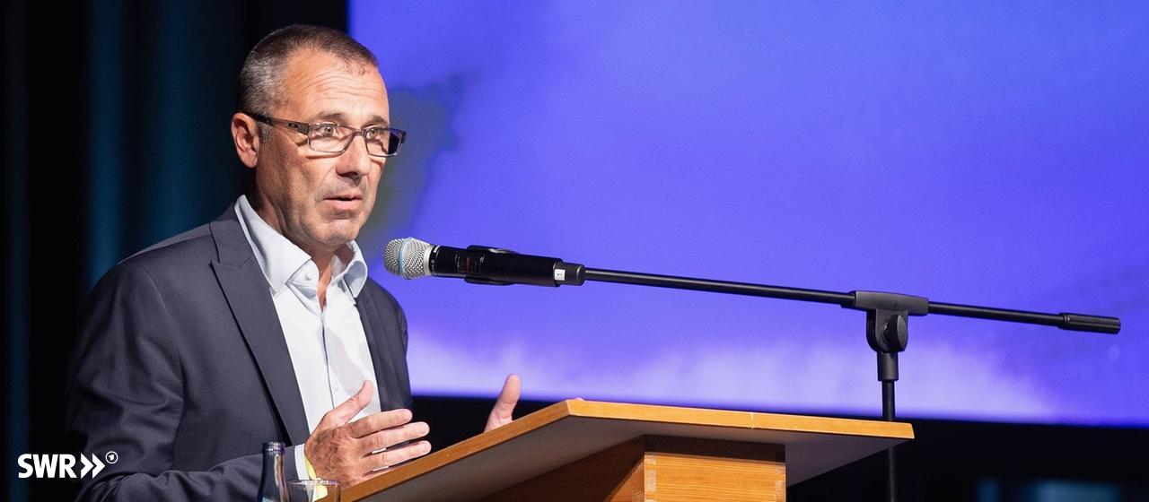 Jörg Albrecht from TSG Hoffenheim at a lectern