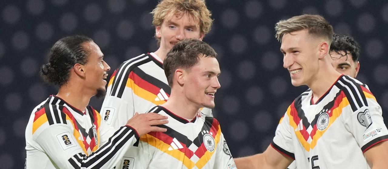Florian Wirtz is celebrated by his teammates for his assist on the goal