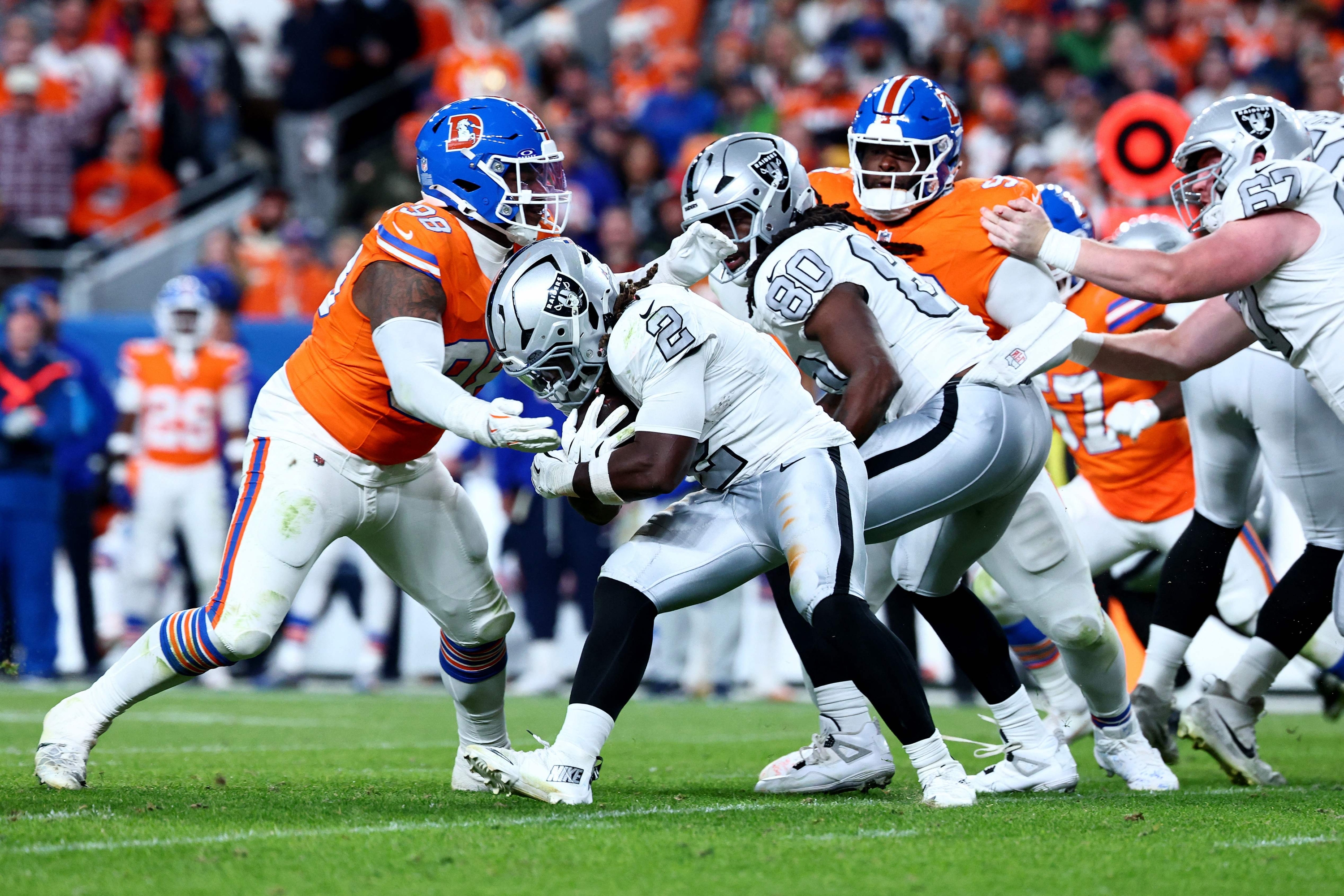 DENVER, COLORADO - NOVEMBER 06: Ashton Jeanty #2 of the Las Vegas Raiders runs the ball against John Franklin-Myers #98 of the Denver Broncos during the third quarter in the game at Empower Field At Mile High on November 06, 2025 in Denver, Colorado. Tyler Schank/Getty Images/AFP (Photo by Tyler Schank / GETTY IMAGES NORTH AMERICA / Getty Images via AFP)