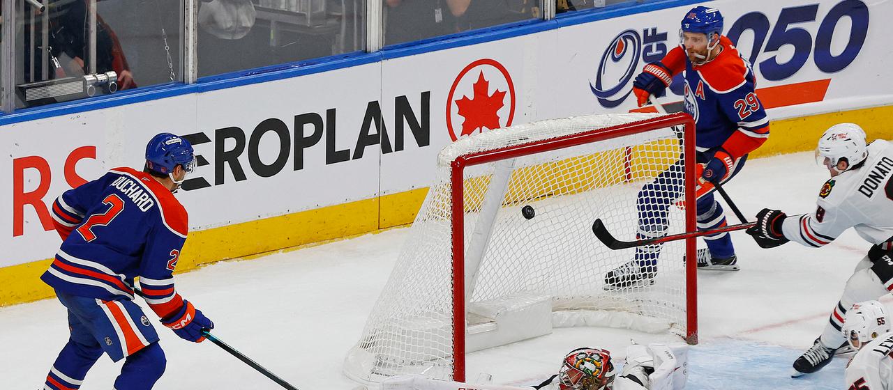 Evan Bouchard scores the Oilers' winning goal after an assist from Leon Draisaitl